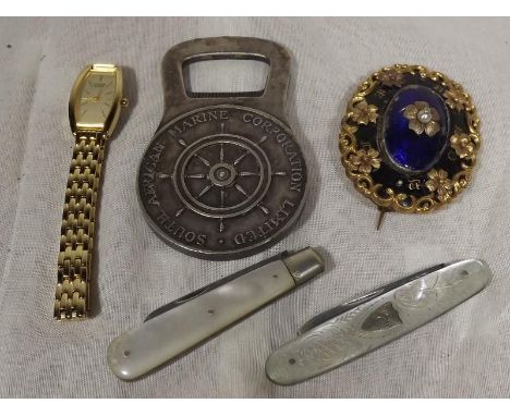 Two silver bladed fruit knives with mother of pearl handles,a white metal bottle opener marked South African Marine Corporati