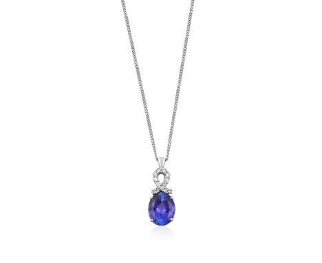 A Tanzanite and Diamond Pendant on Chain the oval cut tanzanite surmounted by a ribbon motif comprised of round brilliant cut