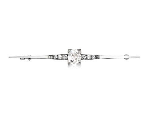 A Diamond Broochthe central cushion cut diamond with eight-cut diamonds at the corners, to a tapered bar inset with graduated