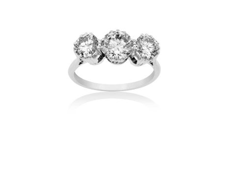 A Diamond Three Stone Ring the graduated round brilliant cut diamonds in white claw settings, to a tapered shoulder plain pol