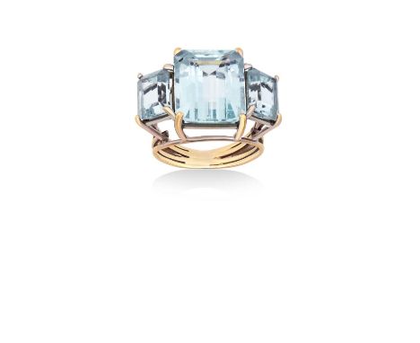 An Aquamarine Three Stone Ringthe graduated emerald-cut aquamarines in yellow claw settings, to a tapered shoulder five row s