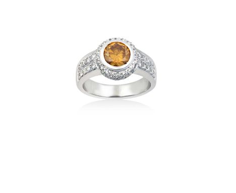 A Diamond Cluster Ring the round brilliant cut fancy deep brownish yellow diamond in white rubbed over setting, to a white ro