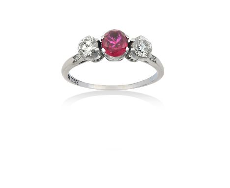 A Ruby and Diamond Three Stone Ringthe round cut ruby flanked by round brilliant cut diamonds, to eight-cut diamond set shoul