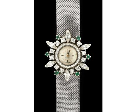 Omega: A Fine Lady's 18 Carat White Gold Diamond and Emerald Set Wristwatch, signed Omega, ref: 7143, 1963, (calibre 640) man