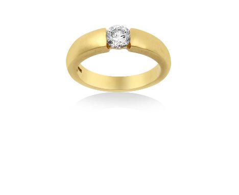 An 18 Carat Gold Diamond Solitaire Ringthe round brilliant cut diamond in a yellow tension setting, to a plain polished shank