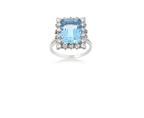 An Aquamarine and Diamond Cluster Ringthe emerald-cut aquamarine within a border of round brilliant cut diamonds, in white cl