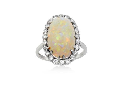 An Opal and Diamond Cluster Ringthe oval cabochon opal within a border of round brilliant cut diamonds, in white claw setting