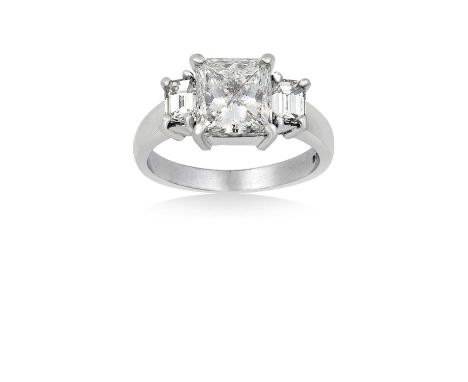 A Platinum Diamond Three Stone Ringthe central princess cut diamond flanked by emerald-cut diamonds, in claw settings, to a t