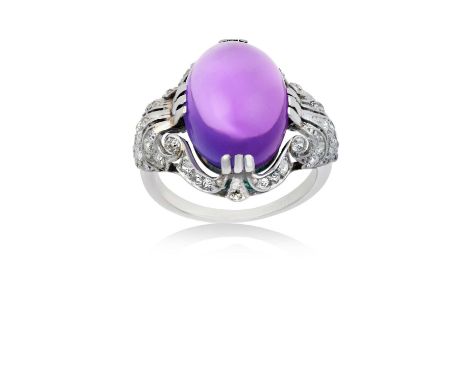 An Amethyst and Diamond Ringthe oval cabochon amethyst in a white triple claw setting, to a scroll surround set throughout wi