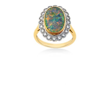 An 18 Carat Gold Opal and Diamond Cluster Ringthe oval opal in a yellow rubbed over setting, within a border of round brillia