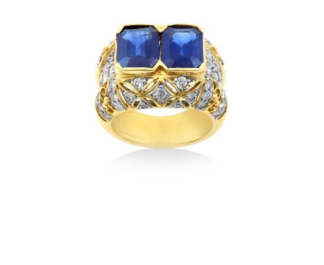 A Sapphire and Diamond Ringtwo emerald-cut sapphires in yellow broad claws, to pavé set round brilliant cut diamonds with pie