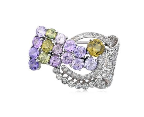 A Peridot, Amethyst and Diamond Broochof scroll form, set throughout with round cut peridot, round cut amethyst, round brilli