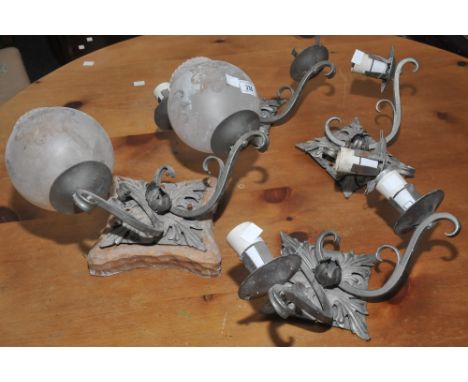 Lighting - a set of four wrought iron two branch wall light fittings, shaped square backs, applied with stylised leaves 
