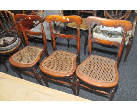 A set of three 19th Century walnut dining chairs, shaped ladder back, cane seats (3)