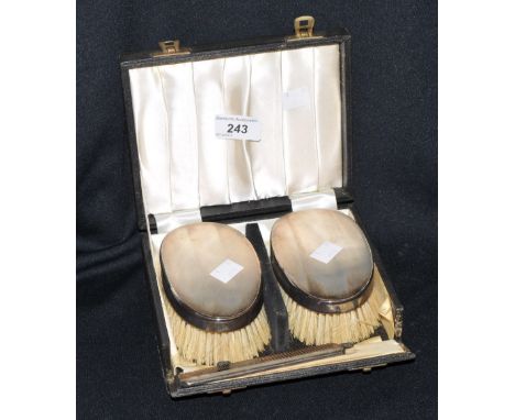 A three piece silver vanity set, two brushes and comb, London 1964