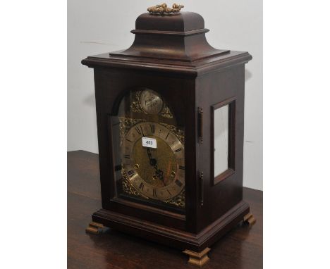 A George III style mahogany bracket clock, by Kieninger, the silvered dial with Roman numerals, three winding holes, striking