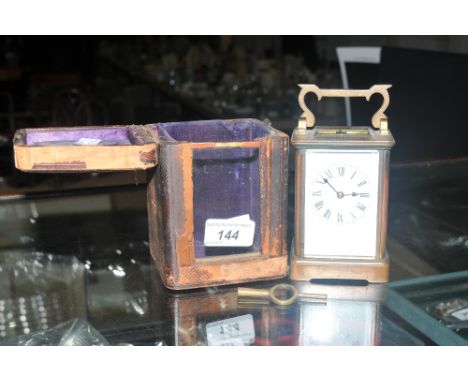 A brass Art Deco carriage clock, white enamel dial; Roman numerals, cased 