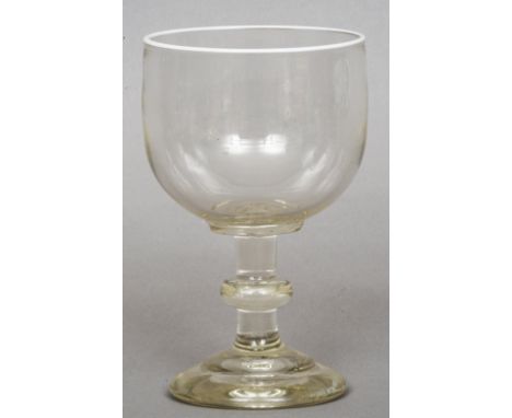 A large 19th century clear glass rummer
The lip decorated with a white enamel band.  20 cm high. CONDITION REPORTS: Some scra
