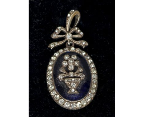 A 19th century blue enamel and paste set yellow metal backed pendant
Of oval form, centred with an urn issuing flowers, the s