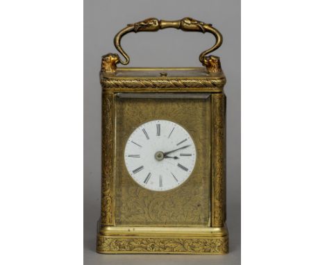 A 19th century brass cased repeating carriage clock
The case with ornate floral engravings, the white enamel dial with Roman 