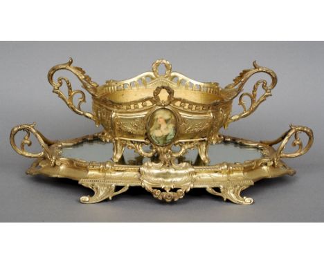 A 19th century French Surtout de Table
C-scroll and acanthus cast with twin handles and mirrored plate; together with an asso