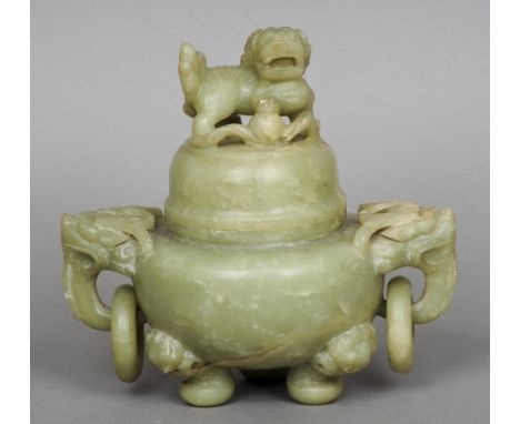 A Chinese carved jade or hardstone censor
The lid carved with a dog-of-fo above the bulbous body with twin dragon mask and ri