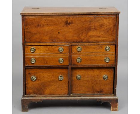 A 19th century campaign chest
The hinged rectangular top enclosing a vacant recess with slide up door above four drawers with