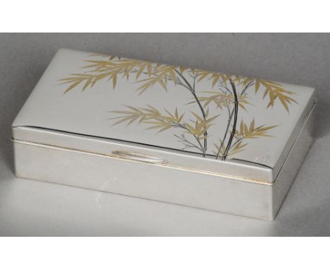 A Japanese silver cigarette box, stamped silver 950
The signed hinged cover with incised and gilt bamboo decoration, in origi