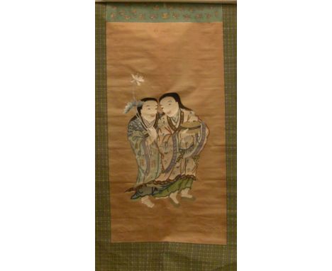 A late 19th/early 20th century Chinese silk work scroll
Centred with two figures, one holding blossoms, the other a circular 