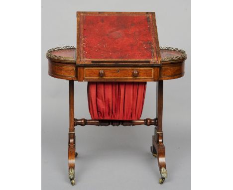 An early 19th century brass inlaid rosewood work/writing table
The leather inset lobed top with a central hinged writing surf