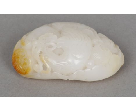A Chinese carved mutton fat and russet jade pebble
Worked with a pair of exotic birds.  6.5 cm long. CONDITION REPORTS: Gener