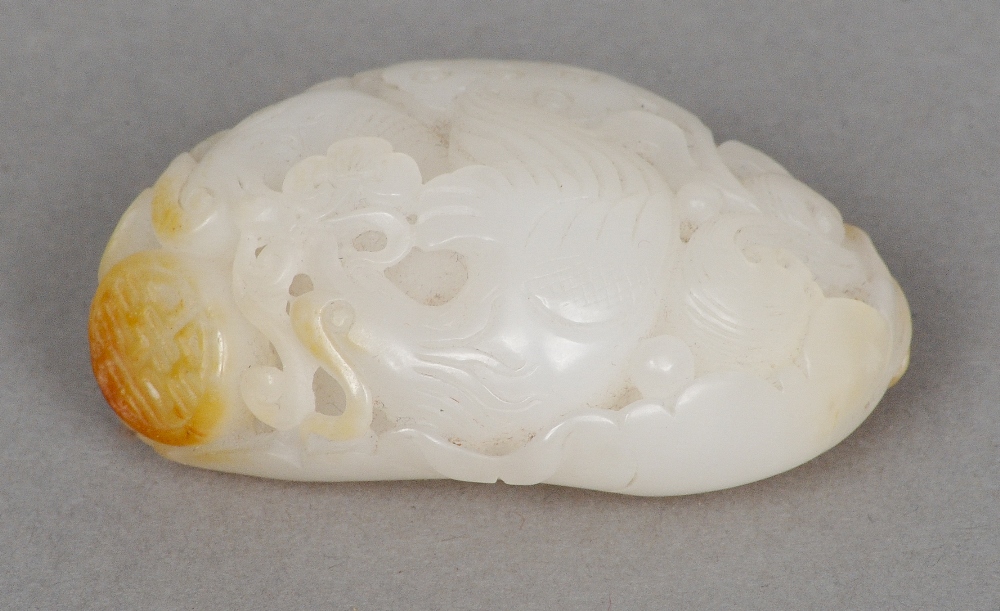 A Chinese carved mutton fat and russet jade pebble Worked with a pair ...