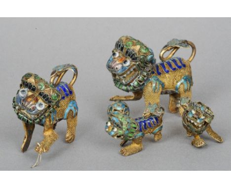 Two pairs of Chinese enamel decorated filigree dogs-of-fo
Each typically modelled.  The larger pair each 8 cm wide.  (4) COND