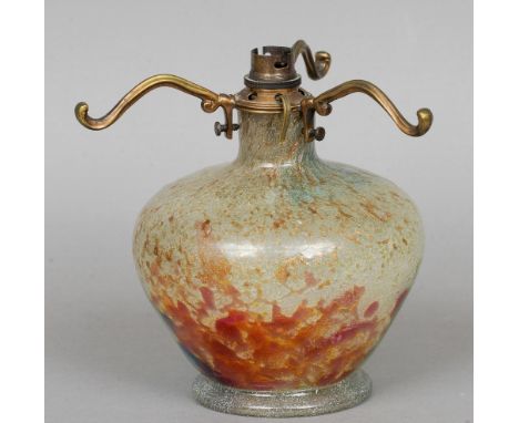 A Monart glass lamp base
Decorated in mottled green, blue, red and copper tones, the underside with original label.  19 cm hi