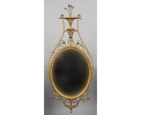 A late 19th century neo-classical carved giltwood wall mirror
The wheat ear issuing fluted vase shaped finial above trailing 