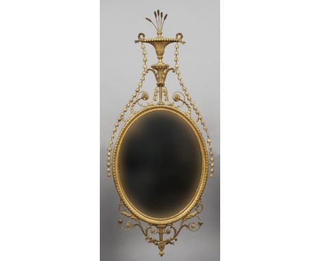 A late 19th century neo-classical carved giltwood wall mirror
The wheat ear issuing fluted vase shaped finial above trailing 