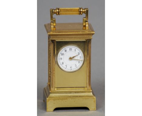 A miniature brass cased carriage clock
Of typical form with a circular enamel dial with Arabic numerals, the side panels with