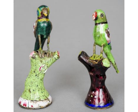 Two 19th century Canton enamel decorated unmarked white metal models of parrots
Each modelled perched on a branch.  The large