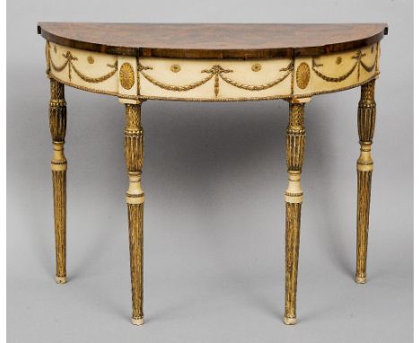 A Georgian inlaid mahogany painted and parcel gilt demi-lune side table
The top with a central patera and a band of bow tied 