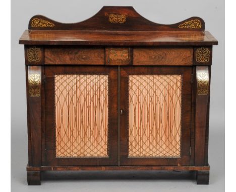 A Regency brass inlaid rosewood side cabinet
The arched shaped back above the line inlaid crossbanded rectangular top over tw