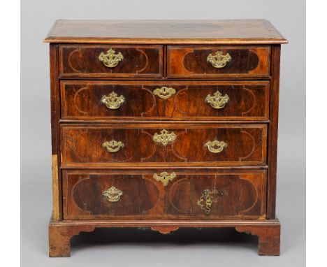 An 18th century walnut chest of drawers
The moulded rectangular top with line inlaid panel decoration above two short and thr