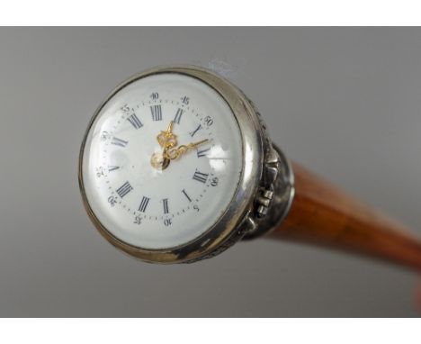 A 19th century walking stick
The thin malacca cane mounted with an unmarked Continental white metal handle inset with a watch