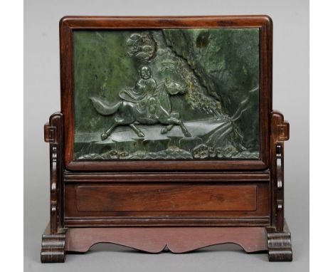 A Chinese hardwood framed carved jade table screen
Decorated with Buddha astride a horse, mounted on a pierced and carved har