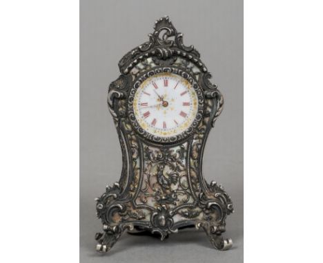 A 19th century Continental unmarked silver and mother-of-pearl desk clock
Of pierced scrolling form, the gilt heightened whit