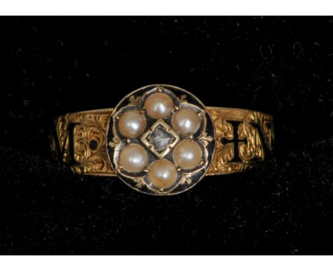 An 18 ct gold enamel decorated diamond and seed pearl set memorial ring
Centred with a small diamond bordered by five seed pe