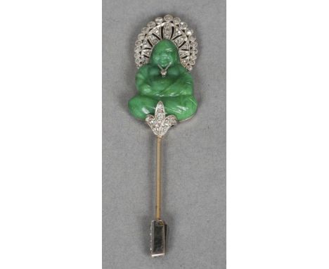 An unmarked, probably white gold, jade and diamond pin
Formed as a jade Buddha with diamond adornments.  6.5 cm high. CONDITI