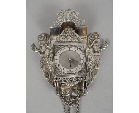 A 19th century Dutch silver miniature wall clock
The domed top with a pierced crest flanked by cornucopia playing caryatids, 