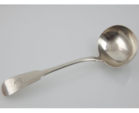 An Irish Georgian silver sauce ladle, Dublin 1812 by Samuel Neville and William Law, engraved crest to handle.