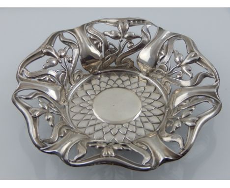 An Edwardian art nouveau silver dish, W. H. Haseler, Birmingham 1905, of circular flower head form with pierced hexagonal bor