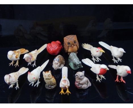 Two Japanese boxwood and hardwood netsuke, together with a collection of carved bone birds and ceramic animals. 